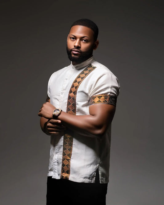 Man wearing a white shirt with patterned sleeves against a dark background Modern Habesha Men’s Shirt Stylish Ethiopian Traditional Wear