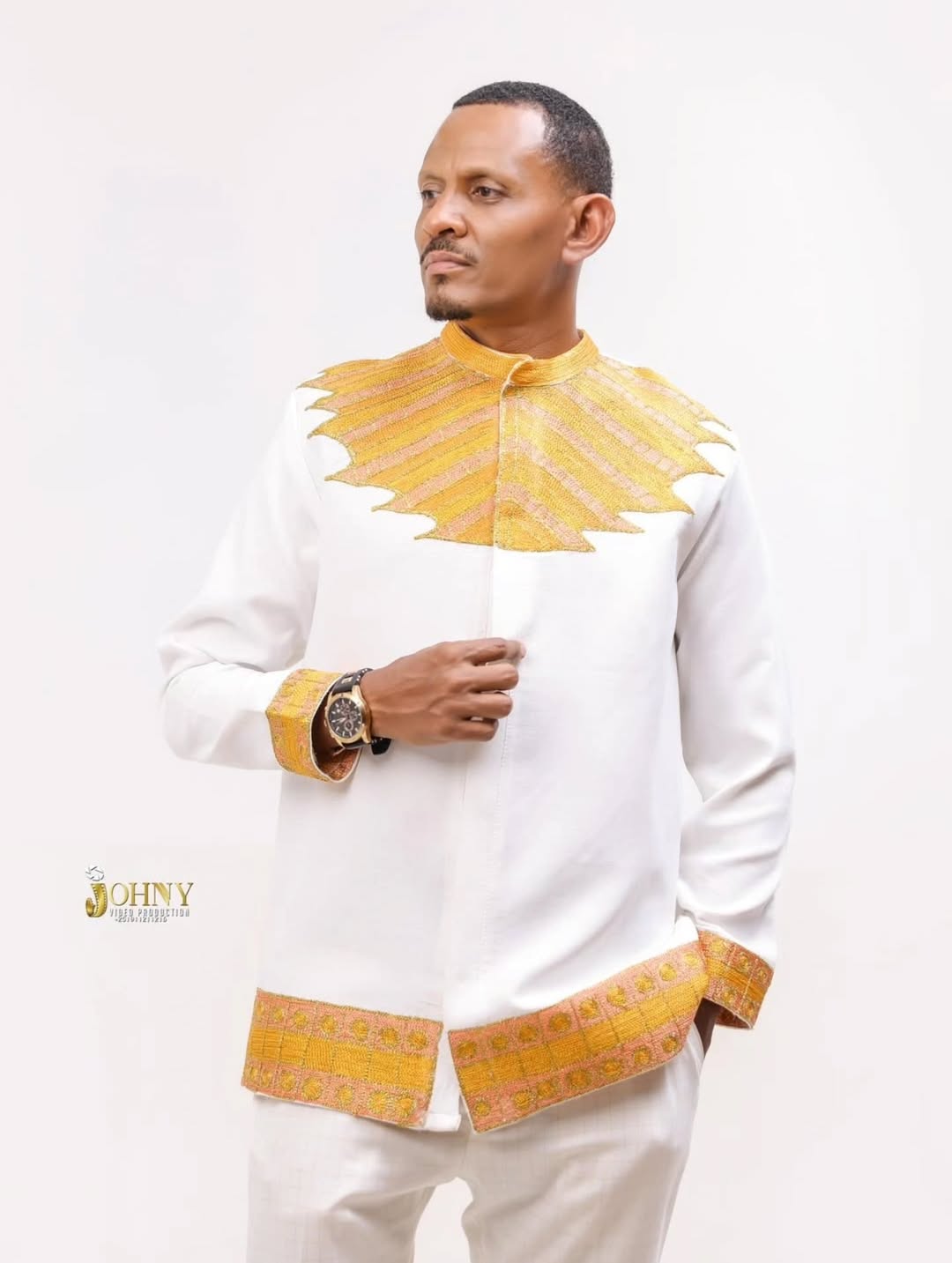 Man wearing a white outfit with yellow accents on a white background Gold Habesha Men’s Shirt New Modern Ethiopian Traditional Wear ethgebya gebeya usa habesha men