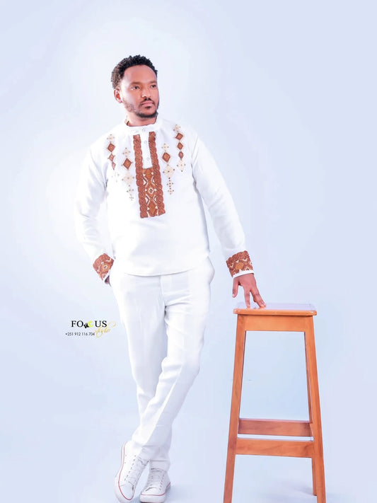Man wearing a traditional outfit with intricate patterns on a white background Ethiopian gown, Habesha wedding dress, Eritrean evening dress, Ethiopian traditional gown, Ethiopian heritage dress, Habesha chic, Eritrean cultural attire, Habesha elegant dress, Eritrean bridal wear, Ethiopian vintage dress, Habesha bridesmaid dress, African ethnic dress, Ethiopian handcrafted dress, Eritrean handcrafted dress, traditional African gown, Habesha festive dress, Ethiopian formal wear,