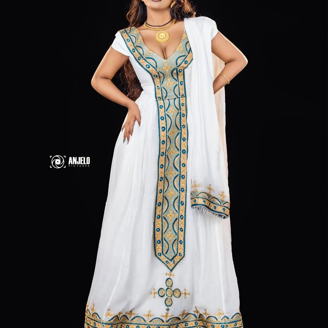 White dress with blue and gold embroidery on a black background. Green & Gold Zuria Habesha Kemis Ethgebya