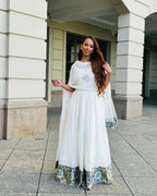 Woman in a white dress with floral hem standing in front of a building Luxury Navy, Gold & Green Zuria Kemis