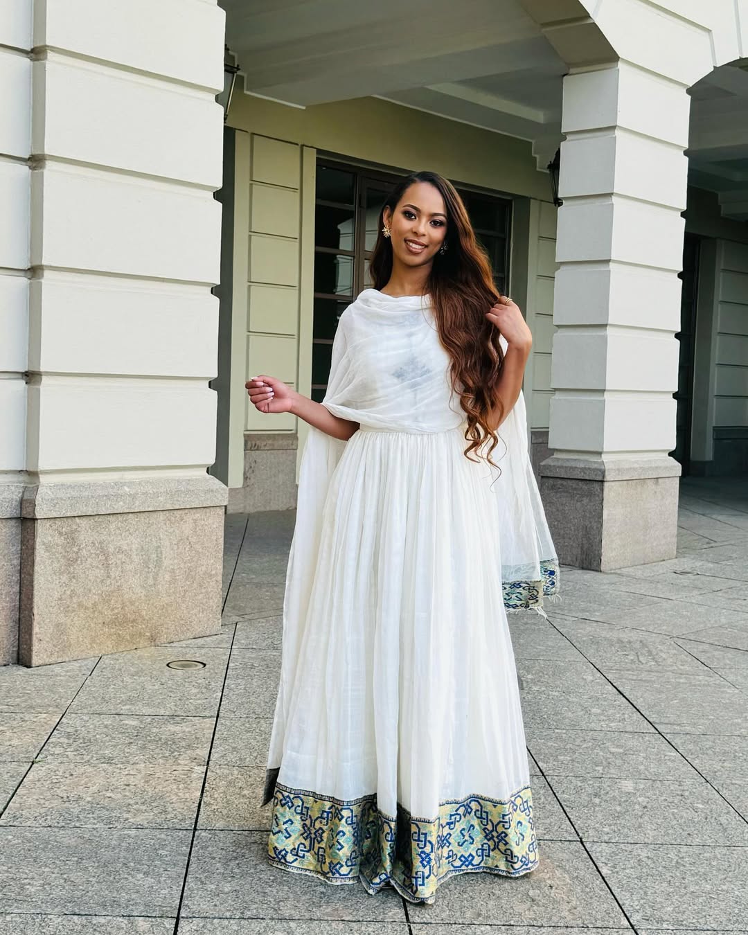 Woman in a white dress with floral hem standing in front of a building Luxury Navy, Gold & Green Zuria Kemis