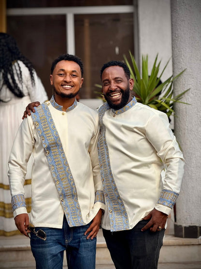 Two men wearing matching traditional outfits standing together outdoors. Modern Habesha Shirt for Men New Ethiopian Cultural Tilet Clothing Ethgebya