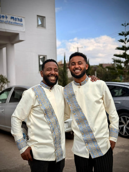 Two men in matching white jackets with blue accents standing outdoors. Modern Habesha Shirt for Men New Ethiopian Cultural Tilet Clothing Ethgebya