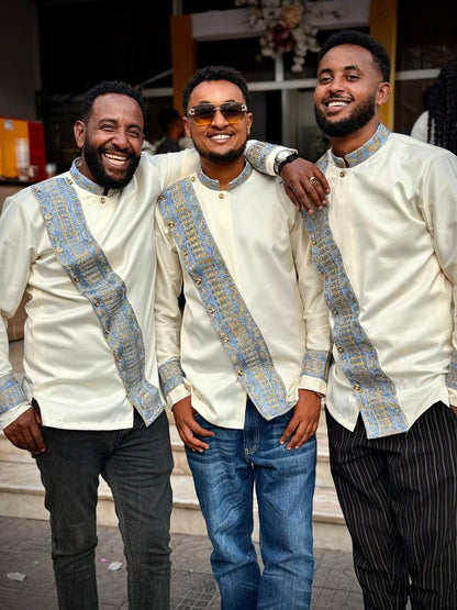 Three men in matching outfits with decorative patterns standing together. Modern Habesha Shirt for Men New Ethiopian Cultural Tilet Clothing Ethgebya