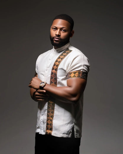 Man wearing a white shirt with patterned sleeves against a dark background Modern Habesha Men’s Shirt Stylish Ethiopian Traditional Wear