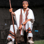 Man in traditional attire holding a spear against a dark background. Oromo Men’s Traditional Clothes Ethiopian Cultural Men's Woya Outfit Ethgebeya