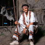 Man in traditional attire holding a staff, with a cow in the background. Oromo Men’s Traditional Clothes Ethiopian Cultural Men's Woya Outfit Ethgebeya