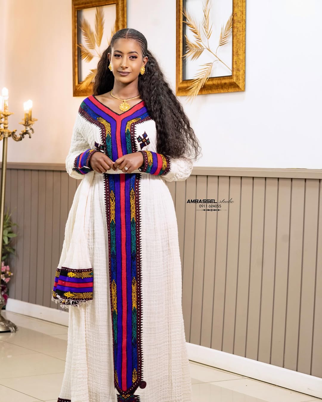 Woman in a traditional outfit with colorful patterns in an indoor setting Elegant Ethiopian & Eritrean Axum Habesha Dress Ethgebya