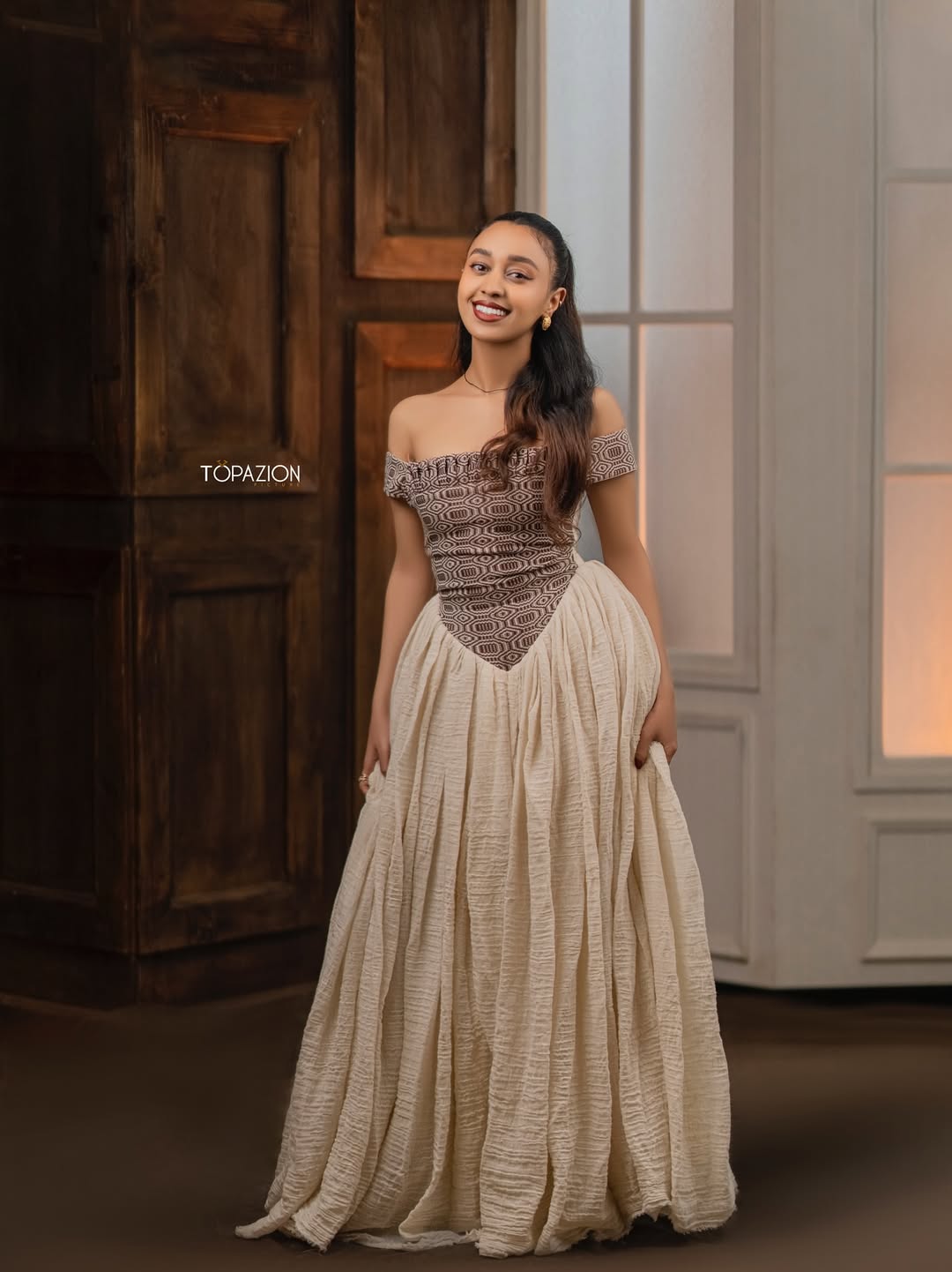 Woman in a two-tone dress standing in a room with wooden and glass Modern Brown & Beige Habesha Kemis ethgebyadoors.