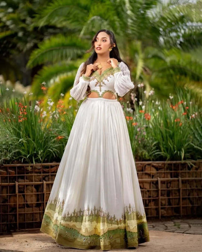 Woman in a white and green traditional outfit standing in a garden. Grass Green Modern Zuria Kemis Elegant Ethiopian Traditional Dress Ethgebya