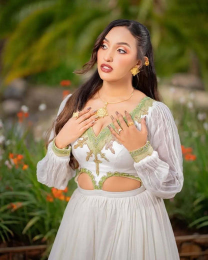 Woman in a white and green traditional outfit standing outdoors with greenery in the background. Grass Green Modern Zuria Kemis Elegant Ethiopian Traditional Dress Ethgebya