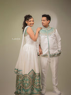 Couple in traditional white and green outfits posing against a plain background Habesha Matching Wedding & Cultural Set Ethgebya