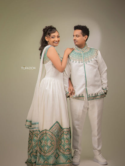 Couple in traditional white and green outfits posing against a plain background Habesha Matching Wedding & Cultural Set Ethgebya