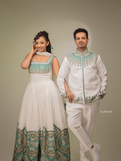 Two individuals in traditional attire standing against a plain background. Habesha Matching Wedding & Cultural Set Ethgebya
