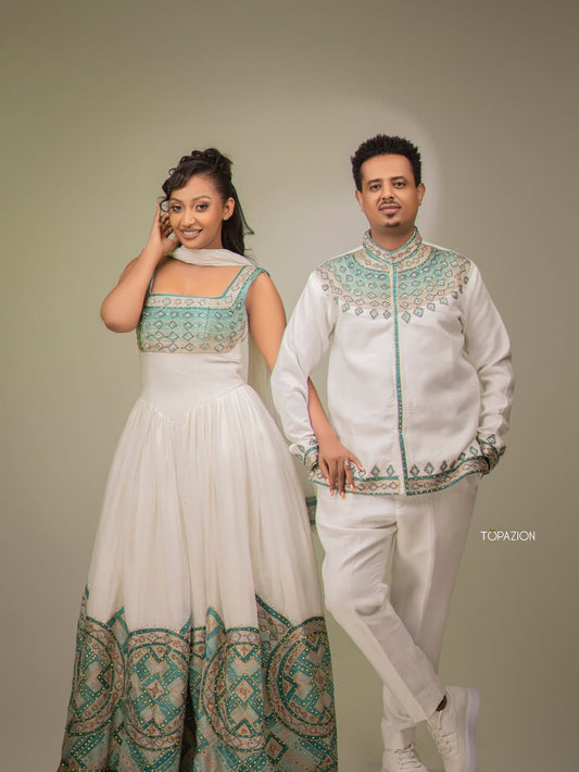 Two individuals in traditional attire standing against a plain background. Habesha Matching Wedding & Cultural Set Ethgebya