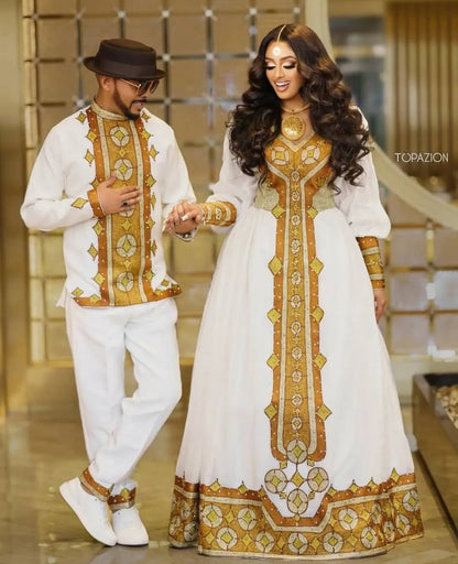 Man and woman in traditional white and gold outfits walking together  Golden Ethiopian Habesha Couple Outfit | New Matching Modern Setindoors.