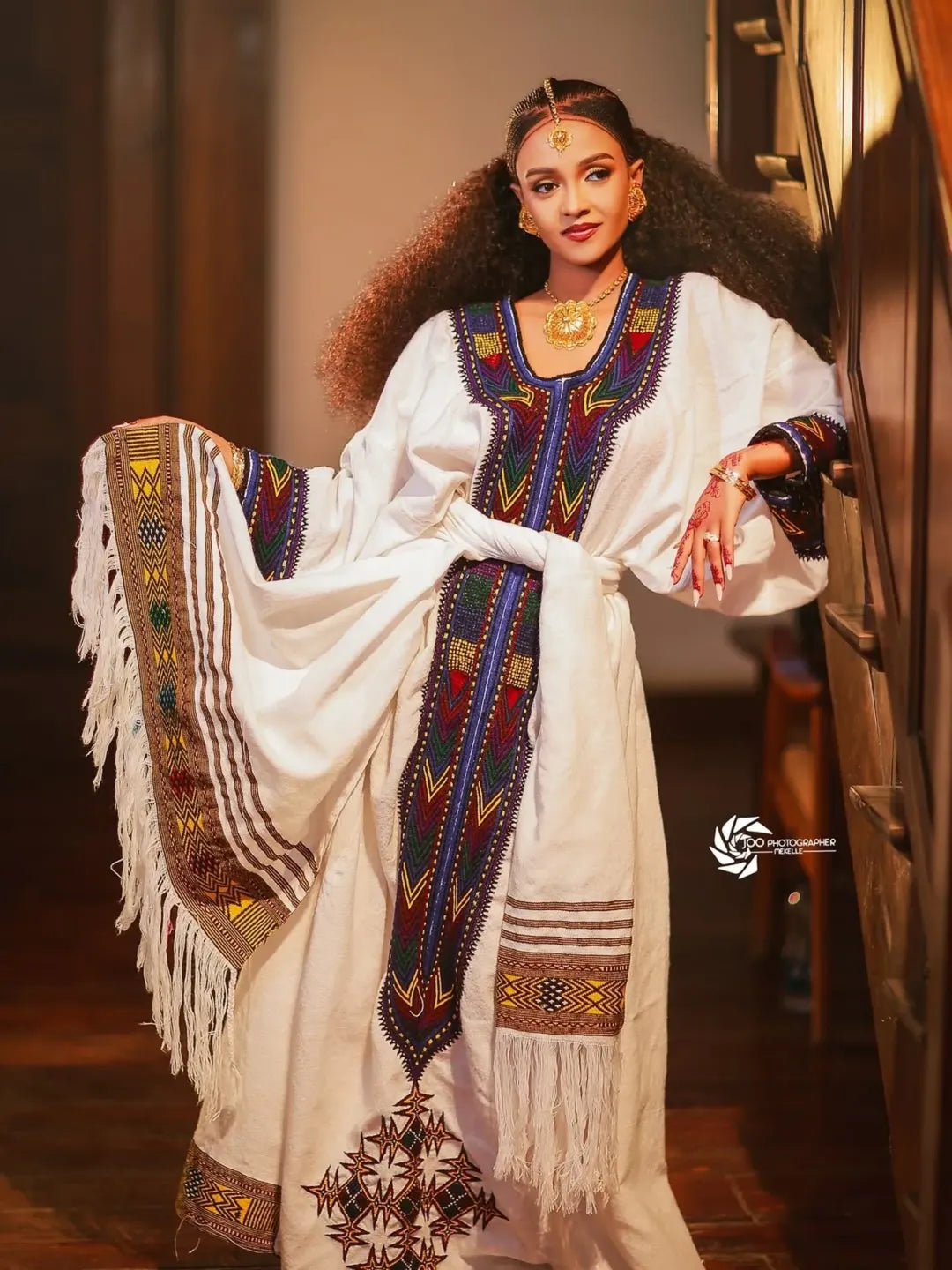 Woman wearing a traditional embroidered outfit with fringes New Ethiopian & Eritrean Axum Habesha Dress Handwoven Tilet Kemis Ethiopia Gebeya Ethgebya