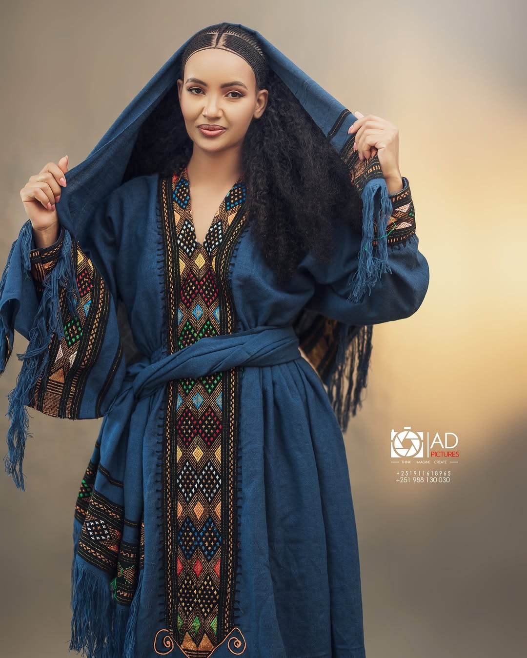 Woman wearing a blue embroidered dress with a hood against a neutral background Dark Blue Raya Cultural Dress Handwoven Ethiopian Habesha Kemis ethgebya gebeya usa habesha kemis