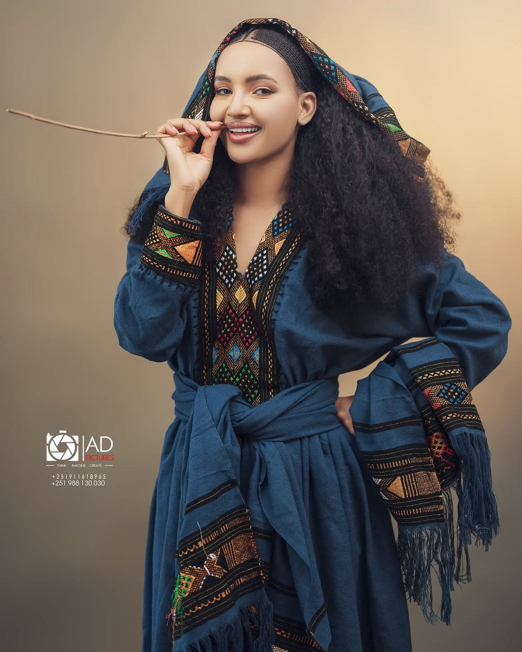 Woman in traditional attire with a decorative headscarf against a beige background Dark Blue Raya Cultural Dress Handwoven Ethiopian Habesha Kemis ethgebya gebeya usa habesha kemis