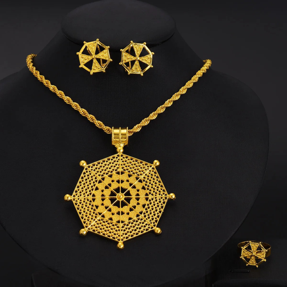 Gold necklace and earrings on a black background