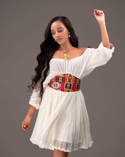 Woman wearing a white dress with a colorful belt against a gray background Red Tilet Habesha Short Kemis New Modern Ethiopian Dress ethgebya gebeya