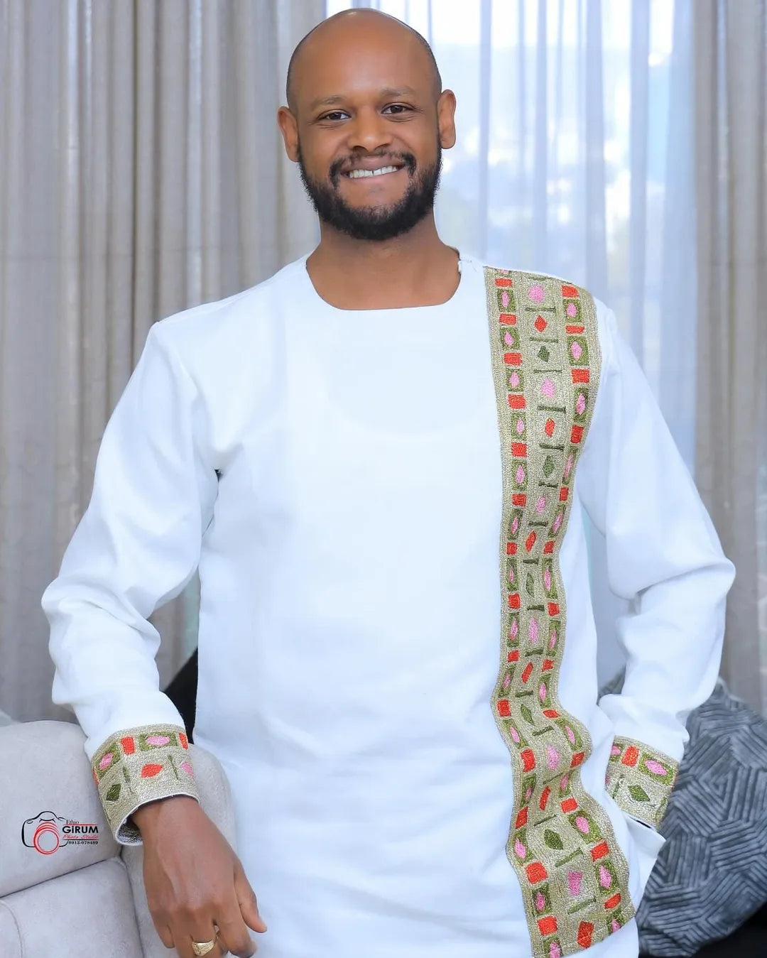 Man wearing a traditional outfit with a colorful sash indoors Golden Modern Habesha Men’s Shirt Ethiopian Traditional Clothing ethgebya gebya 