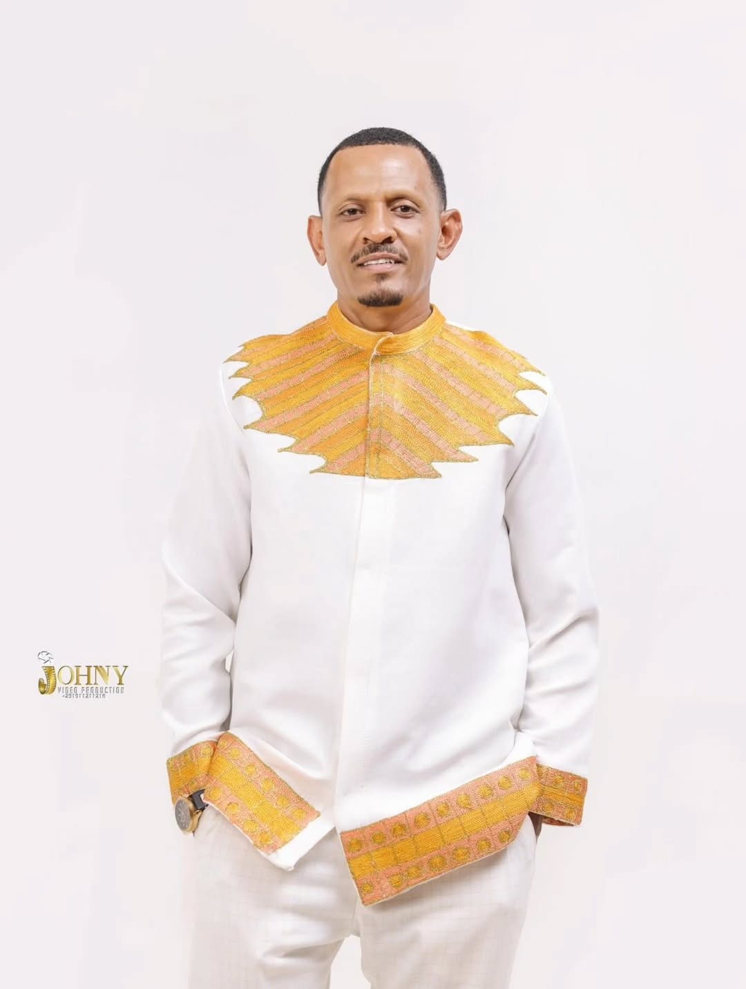 Man wearing a traditional outfit with yellow accents on a white background Gold Habesha Men’s Shirt New Modern Ethiopian Traditional Wear ethgebya gebeya usa habesha men
