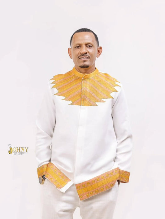 Man wearing a traditional outfit with yellow accents on a white background Gold Habesha Men’s Shirt New Modern Ethiopian Traditional Wear ethgebya gebeya usa habesha men