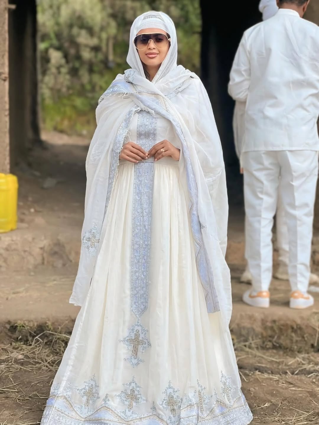 Woman in a white traditional outfit with a headscarf outdoors Silver Modern Habesha Couple Outfit Matching Ethiopian Attire ethgebya gebeya usa habesha kemis