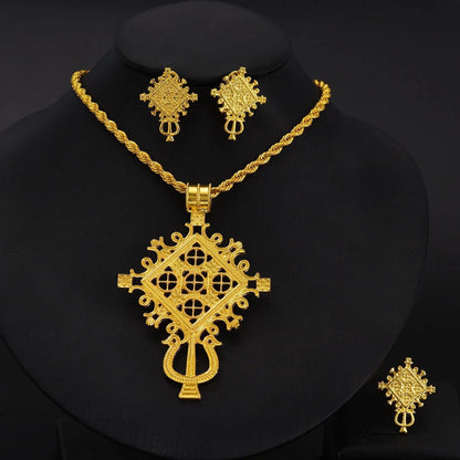 Gold necklace and earrings set on a black background