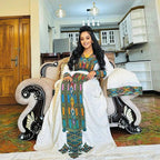 Woman in traditional attire sitting on an ornate chair in a home setting