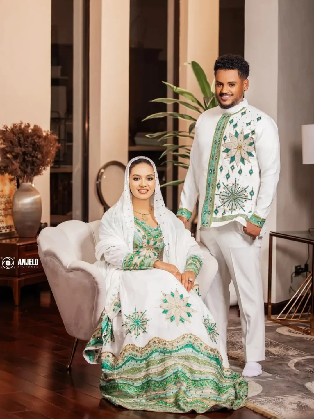 Man and woman in traditional attire sitting in a room with decor elements. Luxury Green Habesha Couple Outfit Matching Ethiopian Attire Set ethgebya gebeya usa habesha couples