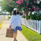 Woman in a white dress with blue trim and straw hat standing on a sidewalk with a white picket fence and pink flowers in the background. modern ethiopian dress habesha traditional dress habesha dress online shopping ethiopian habesha kemis ethiopian kemis habesha libs ethiopian new dress habesha attire fashion ethiopian dress ethiopian women's dress women's ethiopian clothing modern ethiopian traditional clothes habesha cultural dress habesha traditional cloth new ethiopian traditional dress ethiopian tradi