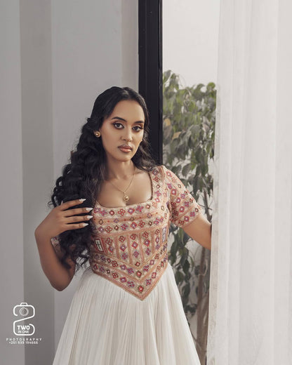Woman wearing a traditional outfit with intricate patterns, standing indoors. Ethiopian Brown Habesha Wedding Attire Matching Couple Set Ethgebya