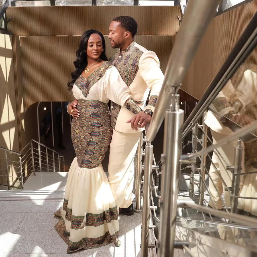 Couple in formal attire standing together in a modern architectural setting