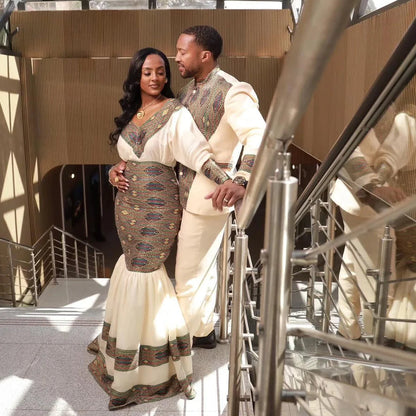Couple in formal attire standing together in a modern architectural setting