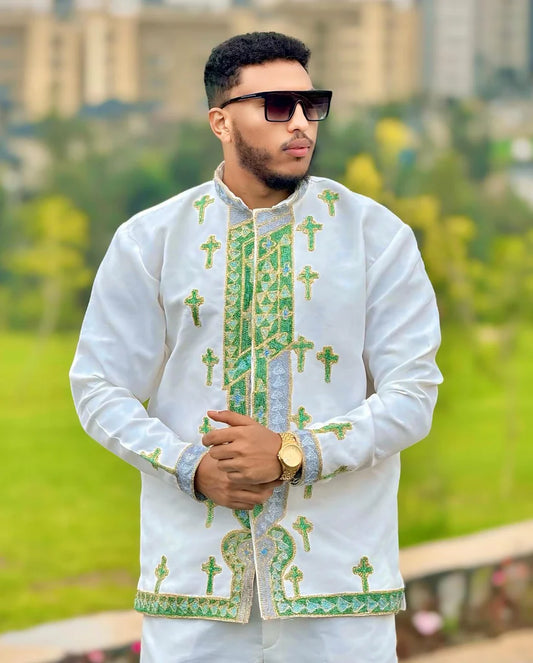 Man wearing a white embroidered shirt with green patterns outdoors. Shop Now & Enjoy Free Worldwide Shipping – Fast Delivery to USA, Canada, UK, and Europe! ethgebya