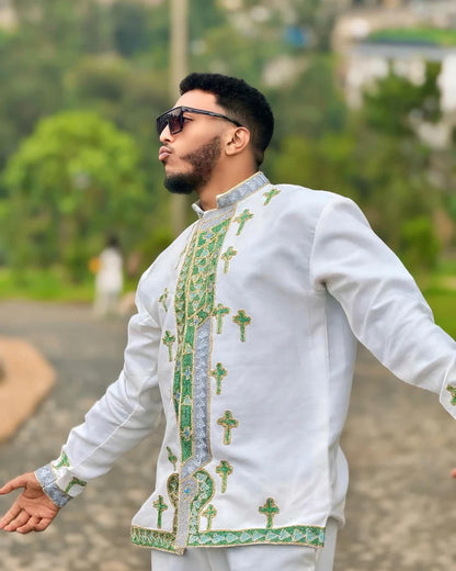 Man wearing a white embroidered shirt with green patterns outdoors. Shop Now & Enjoy Free Worldwide Shipping – Fast Delivery to USA, Canada, UK, and Europe! ethgebya