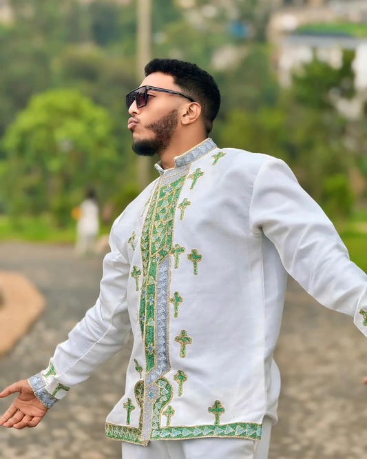 Man wearing a white embroidered shirt with green patterns outdoors. Shop Now & Enjoy Free Worldwide Shipping – Fast Delivery to USA, Canada, UK, and Europe! ethgebya