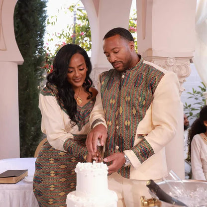Man and woman cutting a cake together at an event with decorative elements.