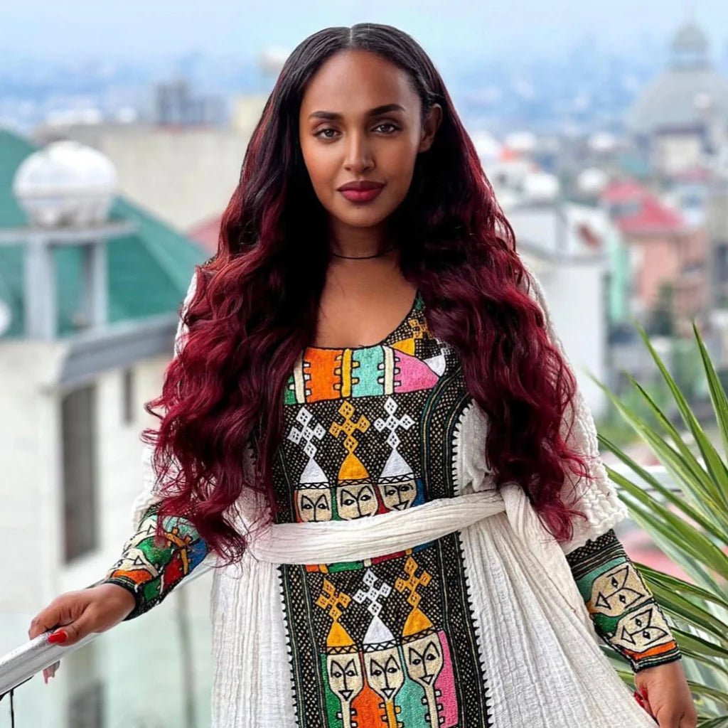 Woman in a colorful traditional outfit with a cityscape in the background