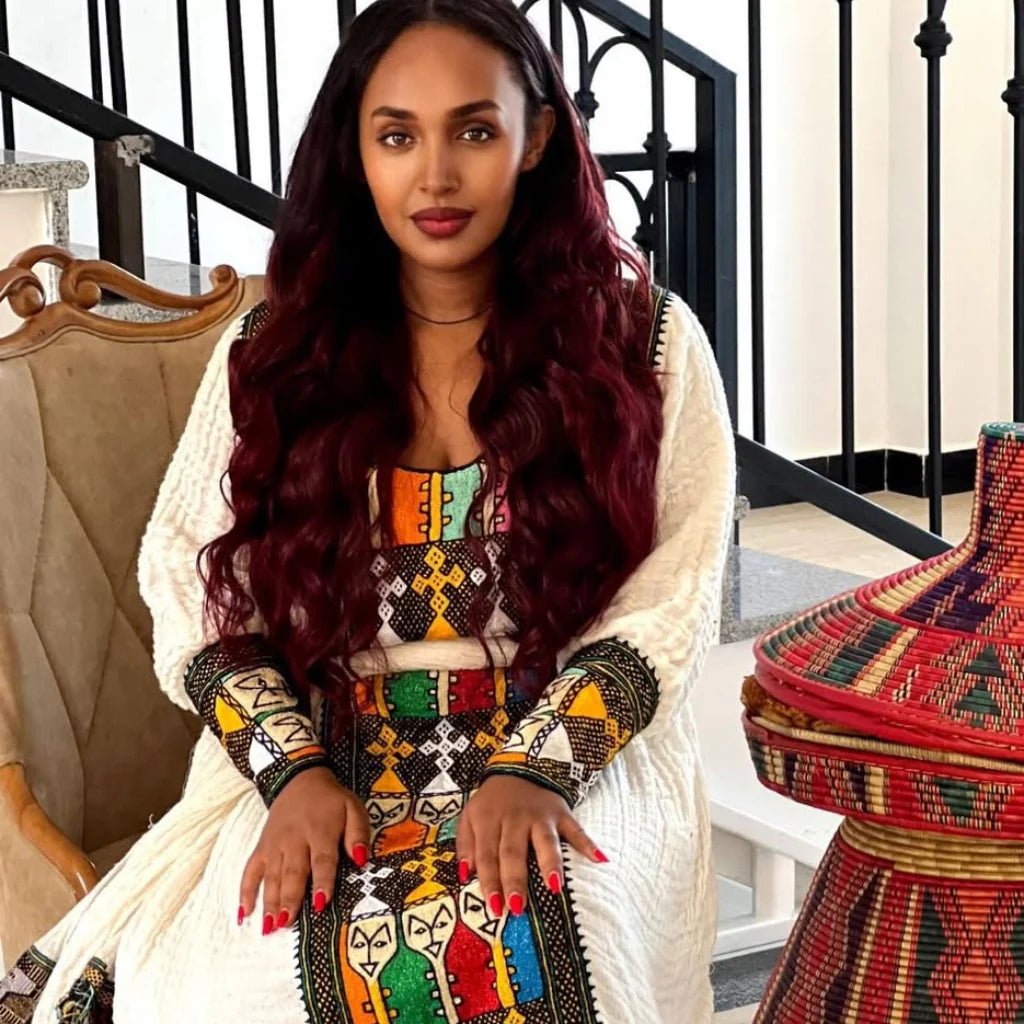 Woman in a colorful traditional outfit sitting on a staircase
